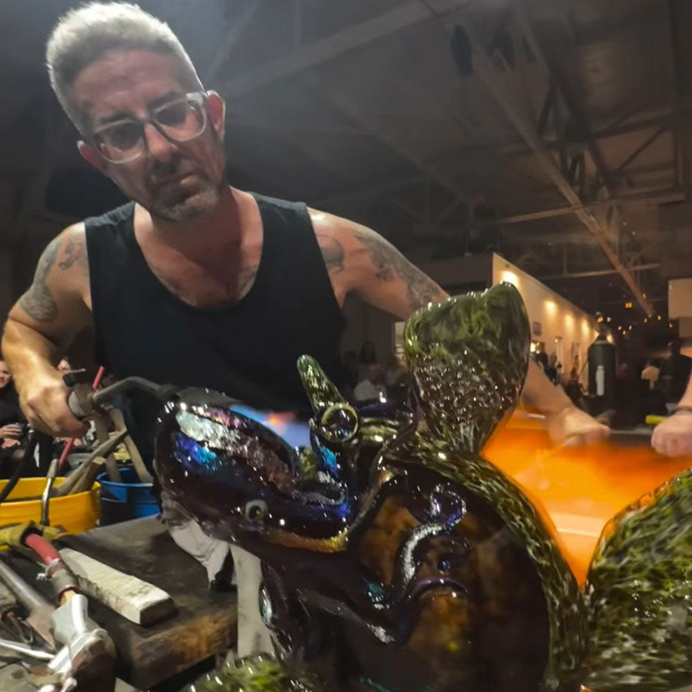 Josh Fradis standing beside his glass installation
