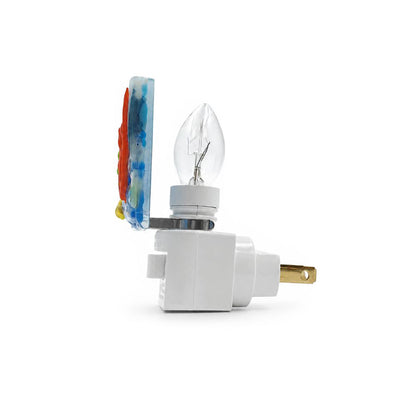Side view of a handmade coral reef nightlight showing the dimensional fused glass panel, clear light bulb, white plug-in base, and brass electrical prongs on a white background.