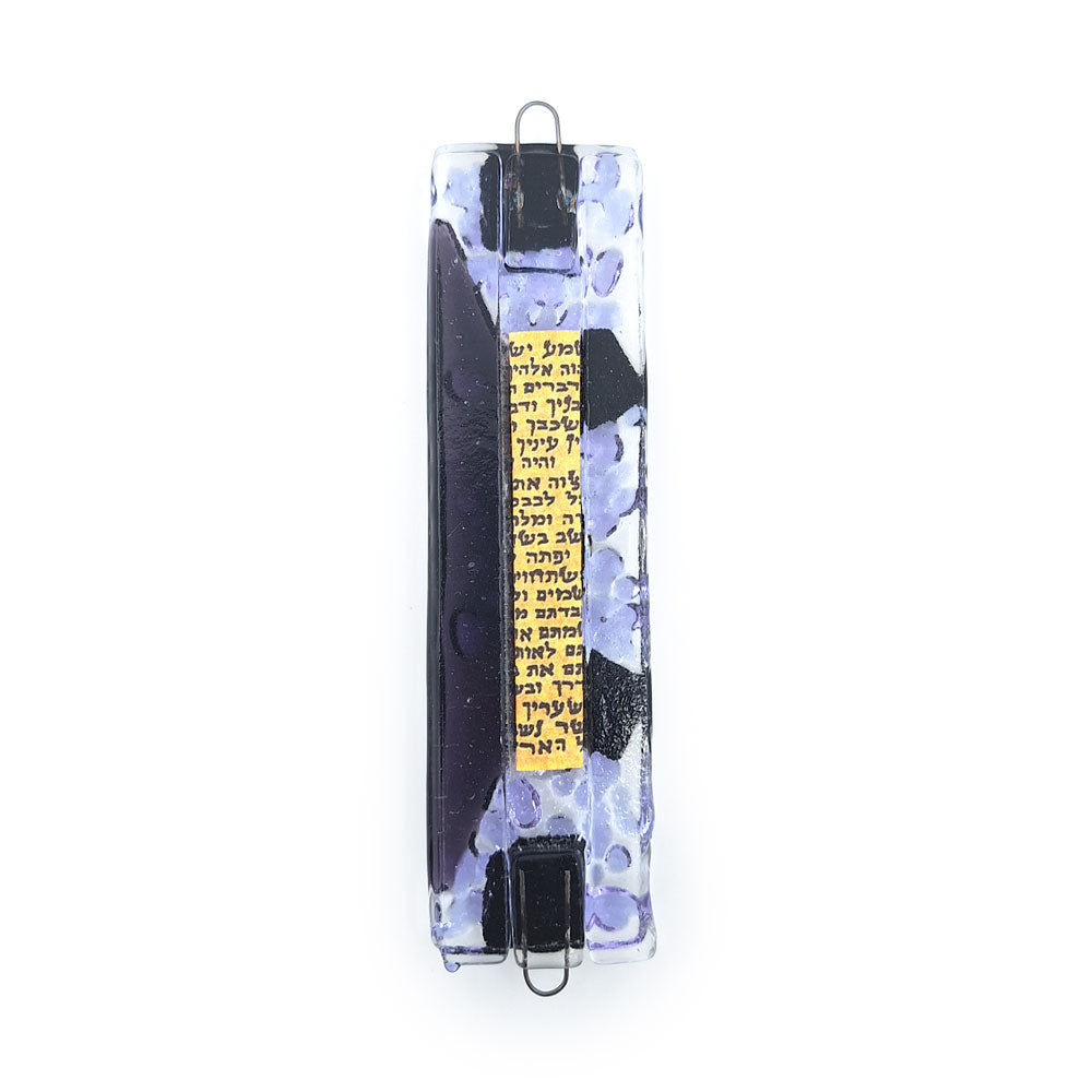 Handmade glass mezuzah featuring a clear textured rectangular base with a dark sculptural center, iridescent striped glass accents, and metal hanging loops on a white background.