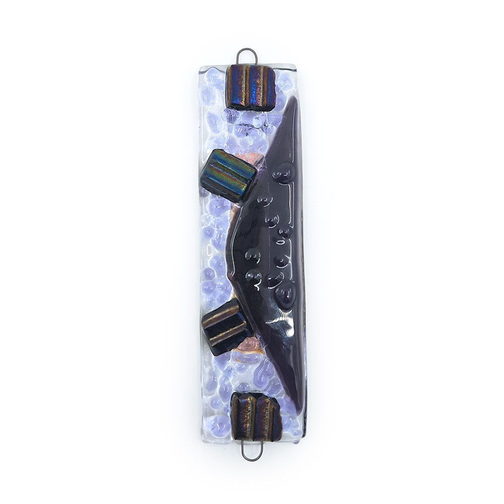 Handmade glass mezuzah featuring a clear textured rectangular base with a dark sculptural center, iridescent striped glass accents, and metal hanging loops on a white background.