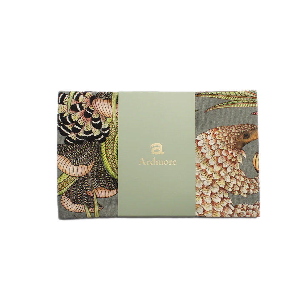 Folded Ardmore pangolin-print tea towel wrapped with a pale green branded paper band.