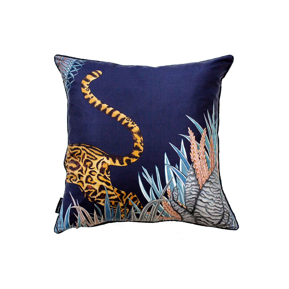 Reverse view of the navy Cheetah Kings Forest Pillow displaying the hindquarters and curved tail of the big cat amid tropical plants against a deep navy backdrop.
