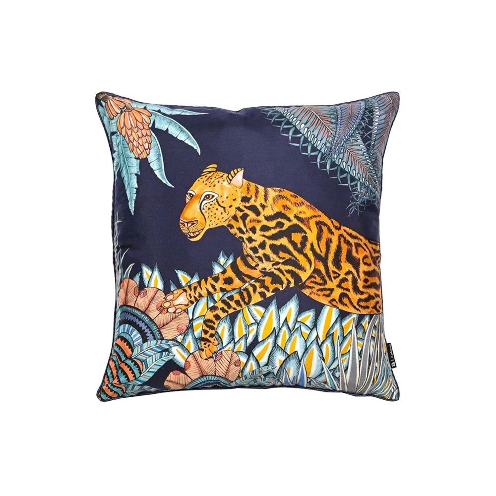 Front view of the navy Cheetah Kings Forest Pillow featuring a spotted big cat walking among vibrant succulents and tropical flora set against a deep navy background. 