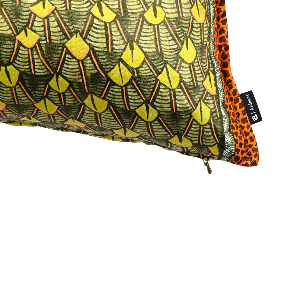 Close-up detail of the Feather Pillow corner highlighting the velvet fabric texture, brand tag, zipper closure, and leopard-print piping.