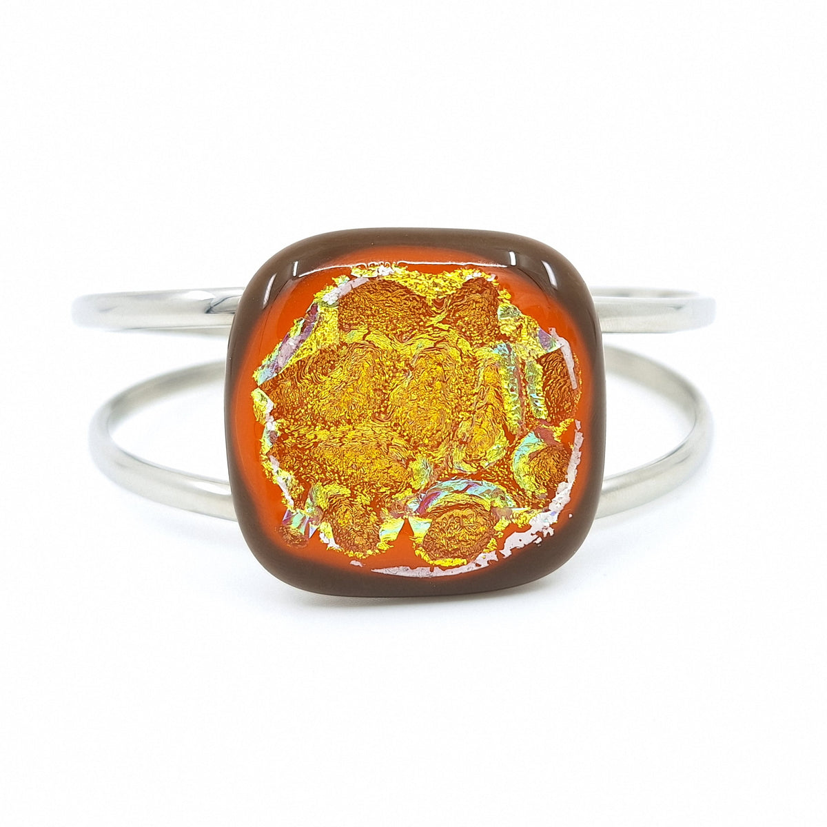 Citrus Supernova bangle bracelet with orange dichroic fused glass on a silver-tone metal band.