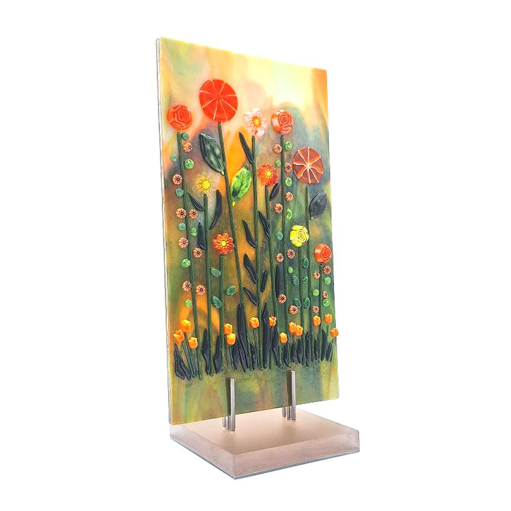 Side view of aventurine green and orange fused glass tulip panel with raised floral details on an acrylic stand.