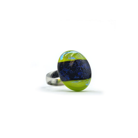 Handmade glass ring featuring an oval lime green and deep cobalt blue glass centerpiece with a silver-tone band, photographed on a white background.
