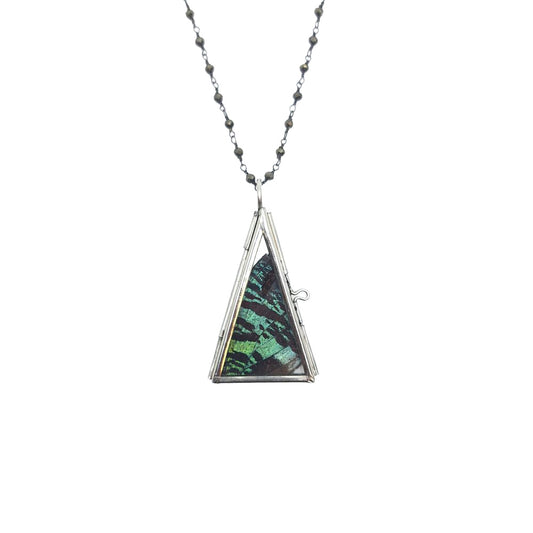 Close-up of triangular sunset moth wing pendant with green, teal, and charcoal iridescent pattern.