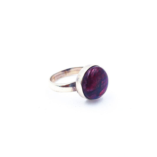 Silver-tone ring featuring a round purple cabochon with marbled burgundy and violet tones, displayed on a white background.