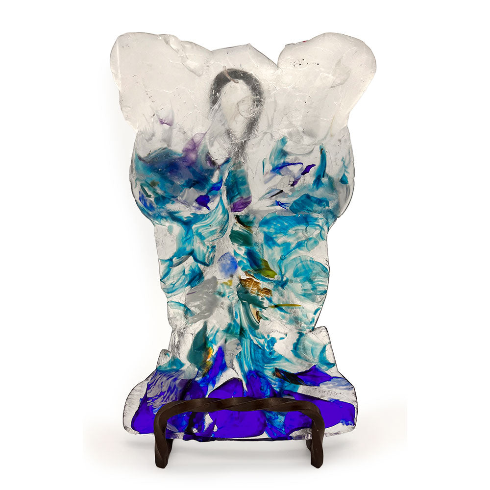 Front view of a handmade translucent glass bust sculpture with layered turquoise, aqua, cobalt blue, purple, and clear glass details, displayed upright on a dark metal stand against a white background.