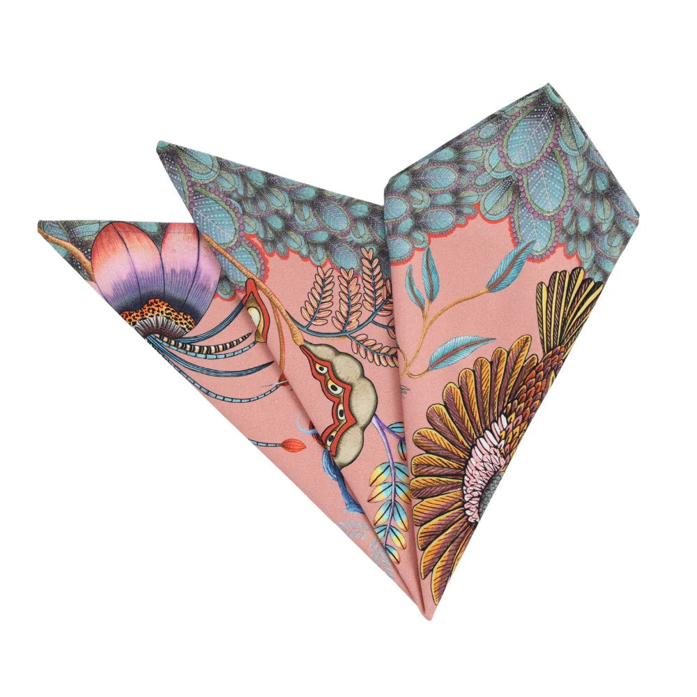 Folded magnolia pink Thanda Nest napkins showing African masked weaver birds, floral details, foliage, and patterned edging.