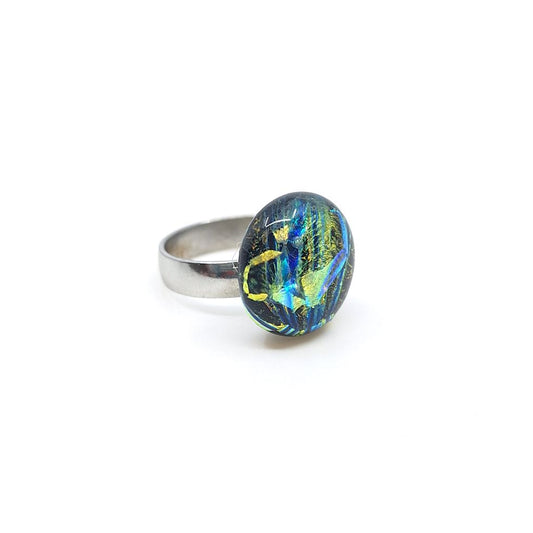 Nebula glass green ring with a round fused glass centerpiece on a silver band.