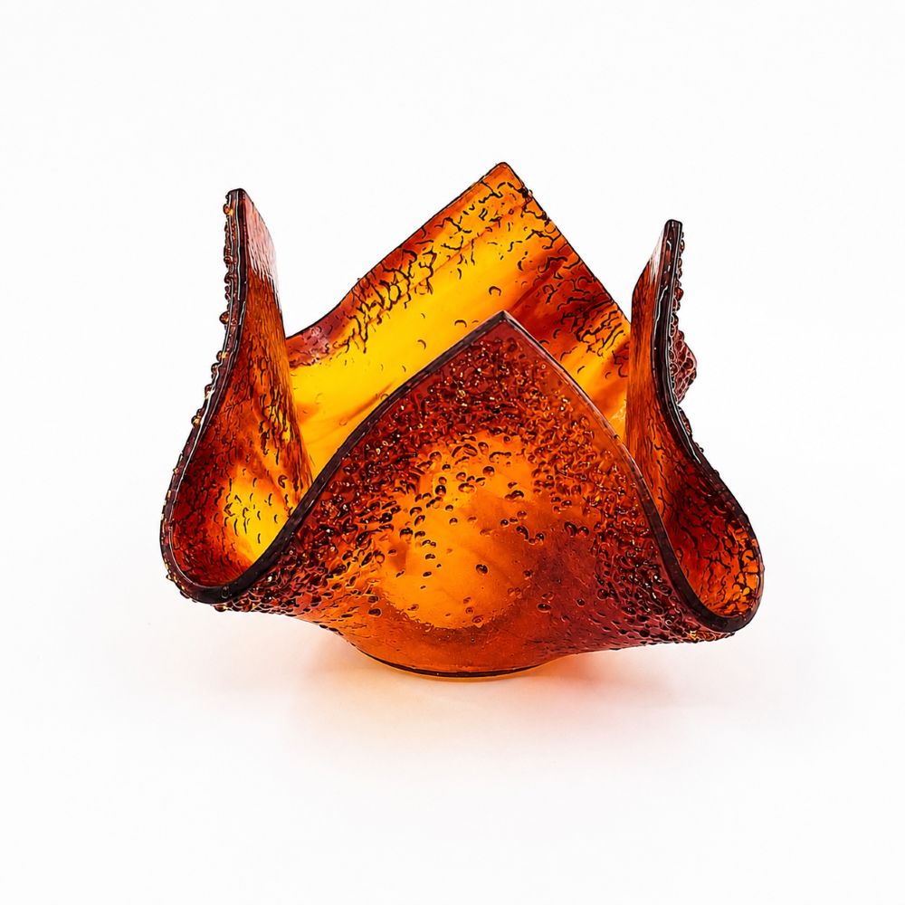 Front view of a handmade red and amber glass tulip candle holder featuring sculpted asymmetrical petals, textured glass details, and deep red edging on a white background.