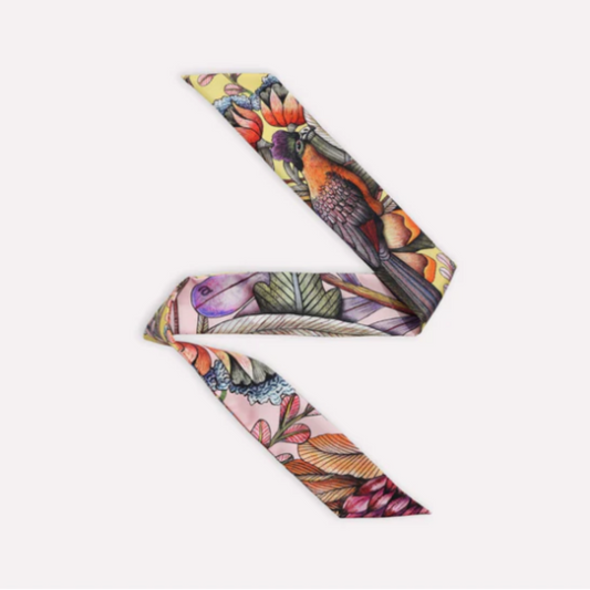 Phinda Pride Flamingo Silk Twill featuring a colorful bird and botanical print in coral, pink, lavender, orange, green, cream, and deep plum tones.