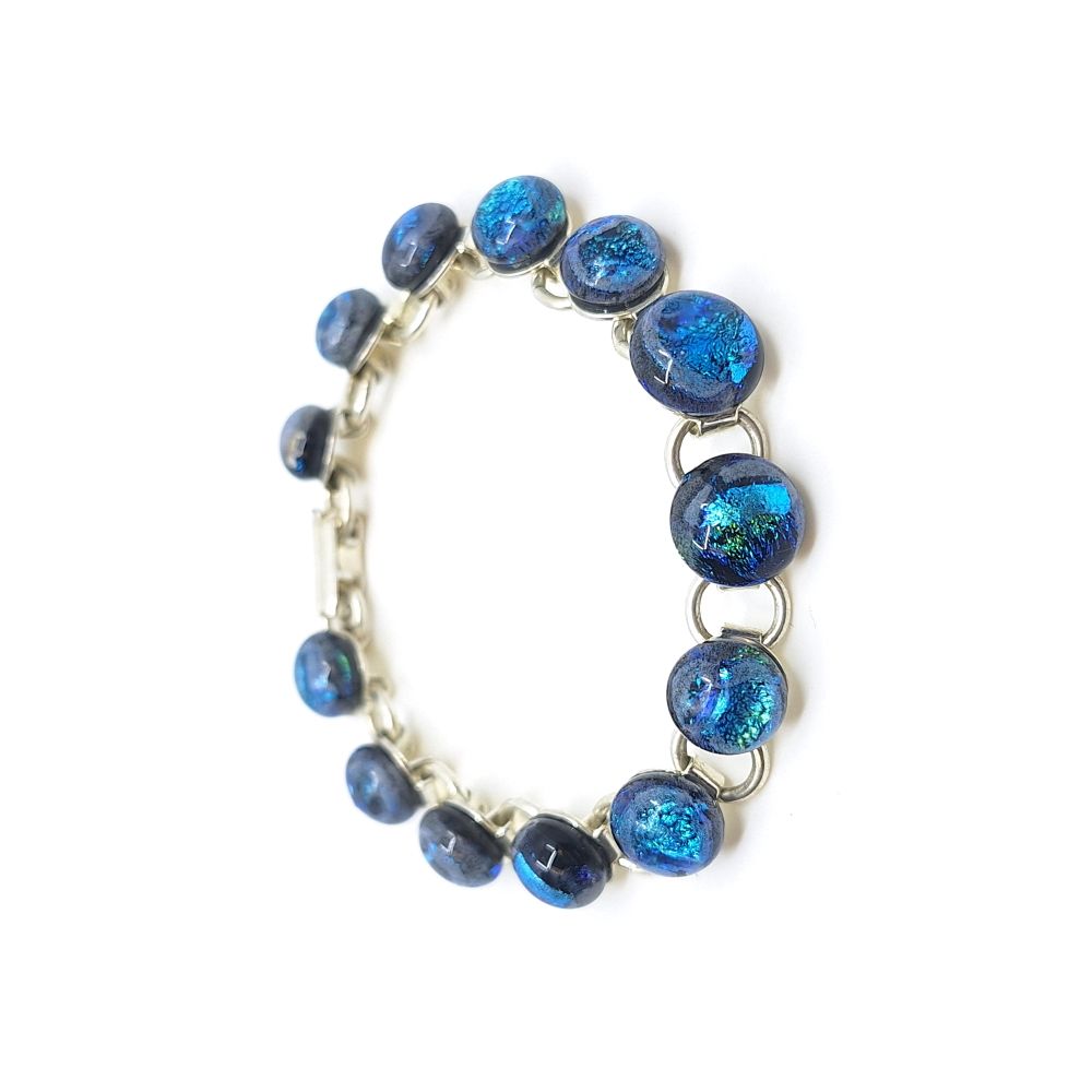 Terra glass bracelet with round blue fused glass links and silver-colored metal.