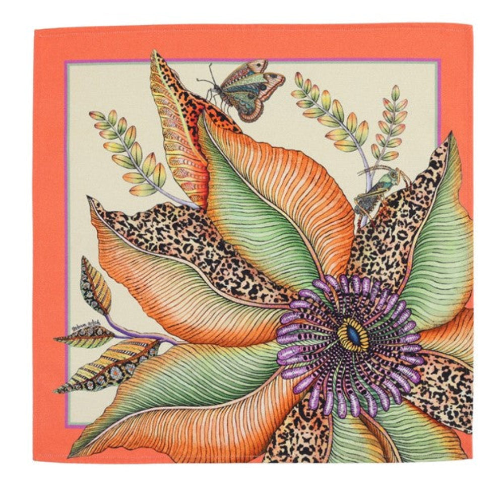 Thanda Bloom napkin with a large orange and green flower, butterfly, foliage, and coral border.