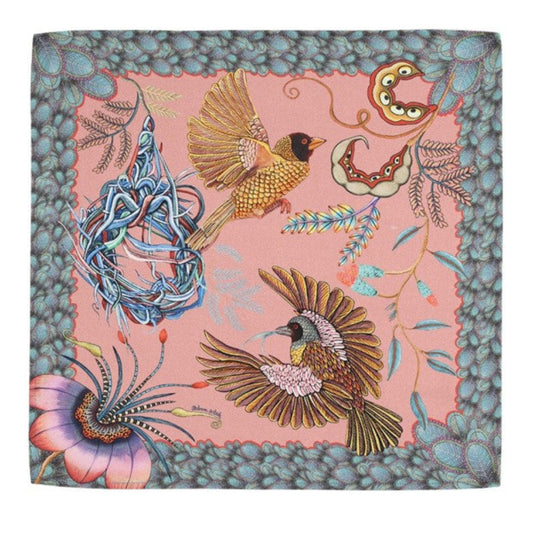 Magnolia pink Thanda Nest napkin with African masked weaver birds, woven nest, flowers, foliage, and patterned border.
