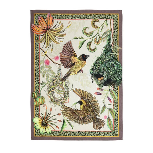 Decorative botanical textile featuring two yellow-and-black birds beside hanging woven nests, surrounded by tropical flowers, vines, seedpods, and a patterned border.