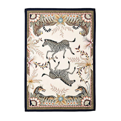 Bush Bandits Tea Towel featuring illustrated zebras and leopards surrounded by stylized flowers, leaves, and decorative borders on a warm cream background.