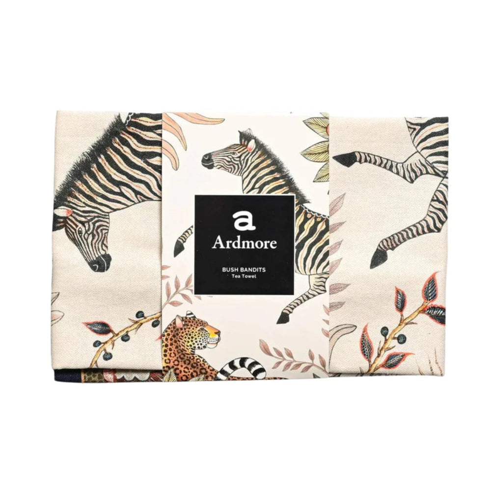 Folded Bush Bandits Tea Towel by Ardmore wrapped with a black branded paper band, showing sections of the zebra, leopard, and botanical print.
