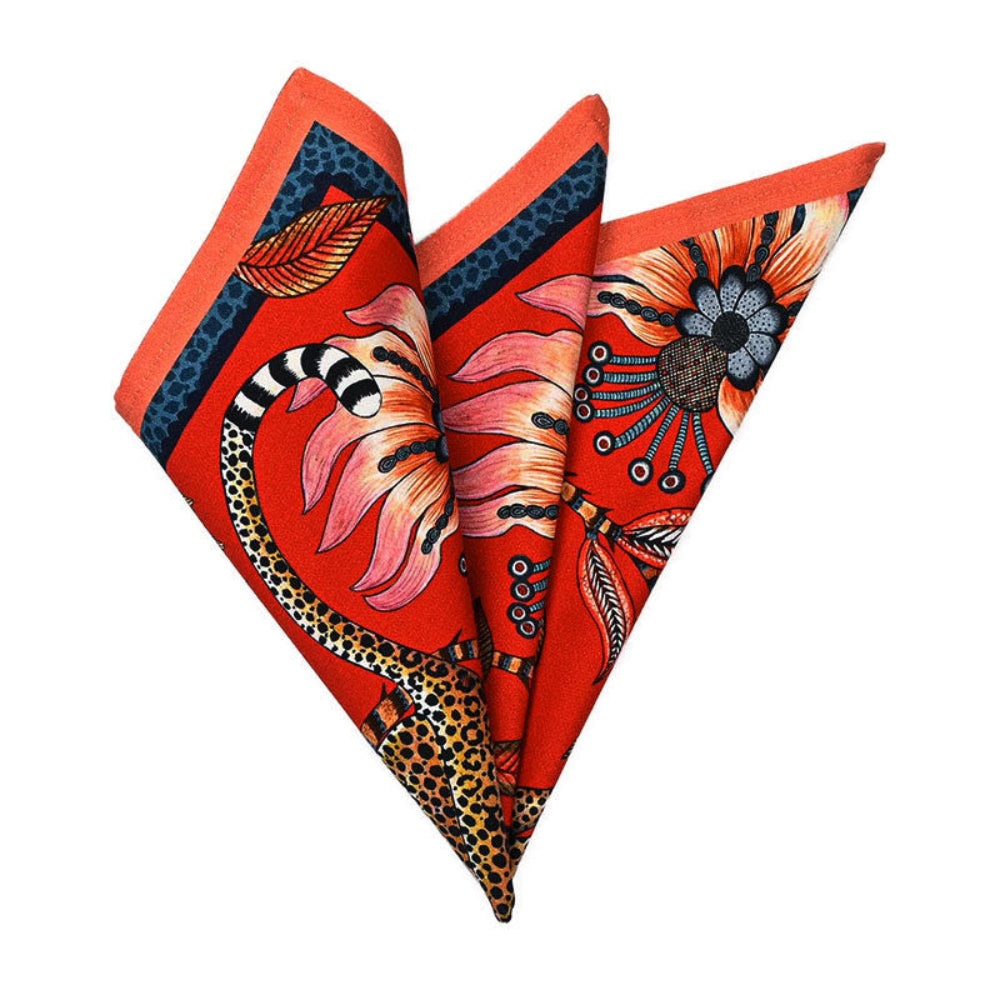 Leopard Napkin folded into a decorative fan shape showing the red floral and leopard print with dark green and orange edging.