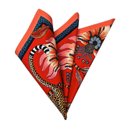 Leopard Napkin folded into a decorative fan shape showing the red floral and leopard print with dark green and orange edging.