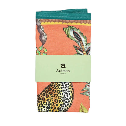 Packaged Leopard Napkins in coral with Ardmore wrap, leopard, foliage, and teal border.