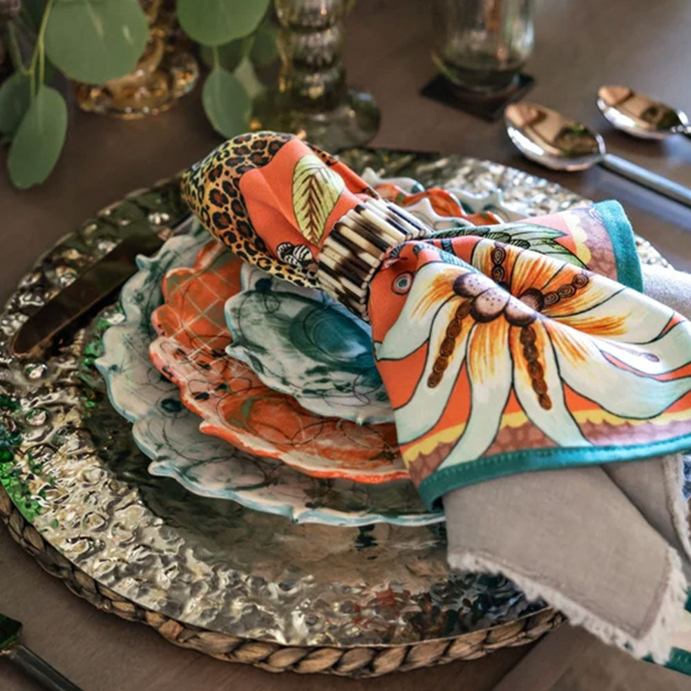 Leopard Napkin styled on a table with floral plate, metallic charger, and colorful Ardmore print.