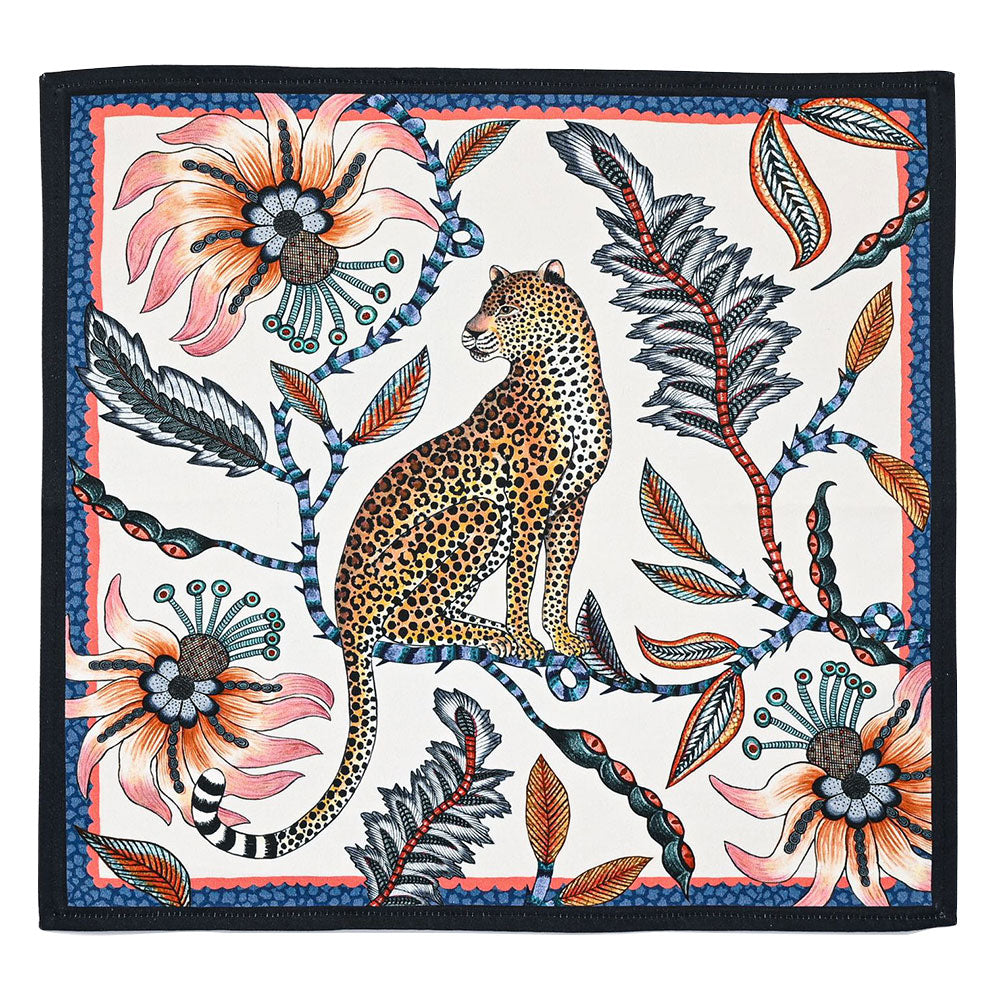 Square cloth napkin featuring a seated leopard surrounded by oversized coral flowers, dark foliage, and colorful botanical details with a navy border.