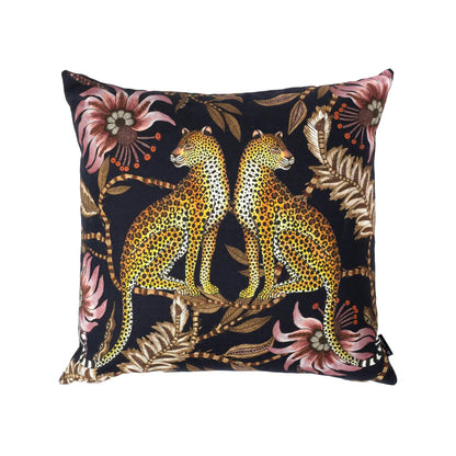 Front view of the back Lovebird Leopards Pillow featuring two symmetrical leopards sitting back-to-back surround by dusty pink floral illustrations and neutral foliage. 