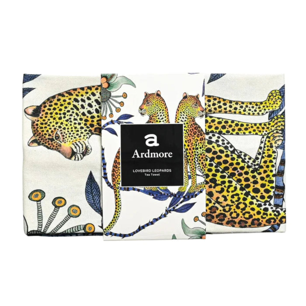 Folded Lovebird Leopards Tea Towel by Ardmore wrapped with a black branded paper band, showing sections of the leopard and botanical print.