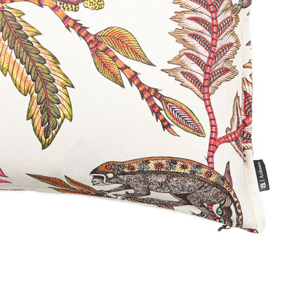 Close-up view of the lower corner of the white Monkey Bean Pillow, highlighting the detailed illustration of a monkey on a branch, seam stitching, and brand tag. 