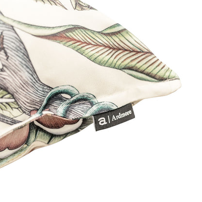 Close-up view of the corner of the Pangolin Park Pillow highlighting the soft cream fabric finish and attached Ardmore brand tag.