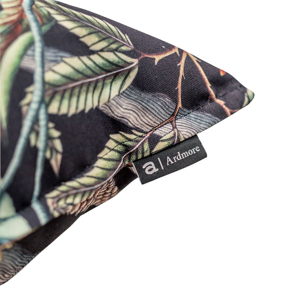 Close-up view of the corner of the Pangolin Park Pillow highlighting the stitched seam fabric finish and attached Ardmore brand tag.