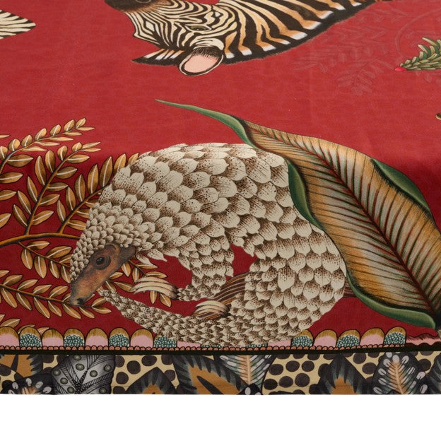 Close-up of the Ardmore tablecloth featuring a curled pangolin surrounded by layered leaves and botanical details.
