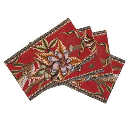 Folded Ardmore table runner featuring zebras, antelope, spotted big cats, oversized flowers, and winding botanical details on a vivid red background.