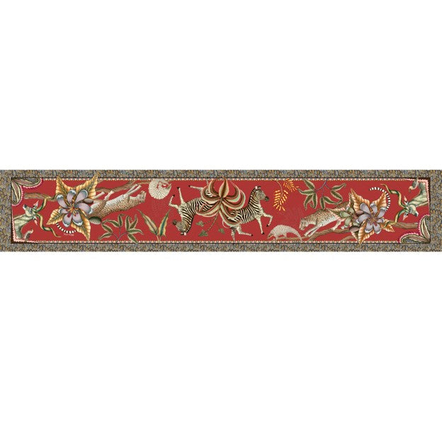Full view of a long red Ardmore table runner decorated with African wildlife, tropical flowers, curling vines, and ornate patterned borders.