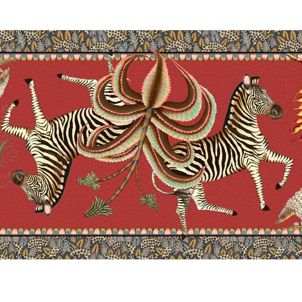 Close-up of the Ardmore table runner featuring two running zebras, a sculptural flower, and intricate patterned borders.