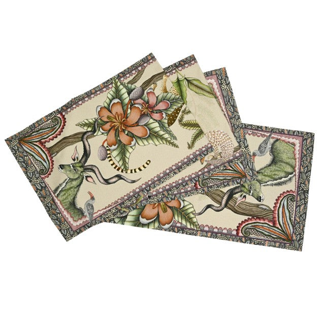 Folded Ardmore table runner featuring antelope, birds, tropical flowers, curling branches, and an ornate patterned border on a cream background.