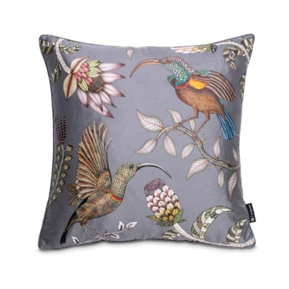 Square gray decorative pillow featuring two colorful long-beaked birds, flowering branches, protea-like blooms, and curling botanical details.