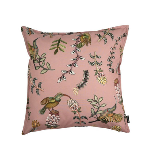 Square blush pink decorative pillow featuring colorful hummingbirds, flowering plants, leafy branches, and scattered botanical illustrations.