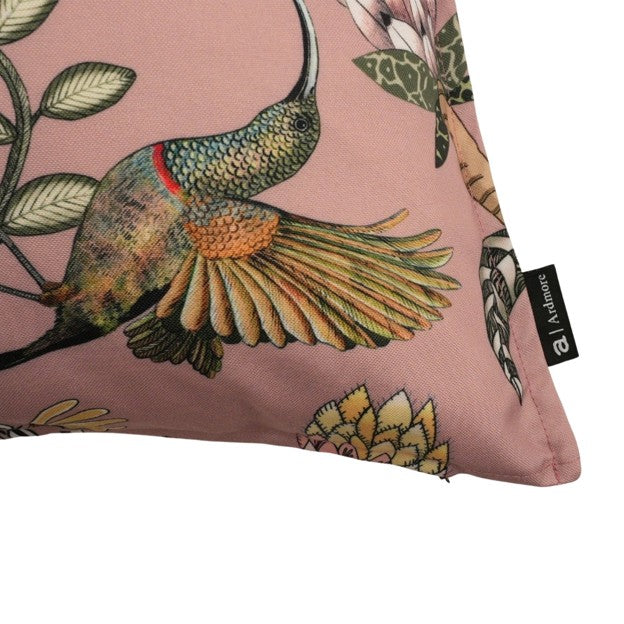 Close-up of the pillow corner showing a detailed hummingbird in flight, botanical accents, and the black Ardmore brand label.
