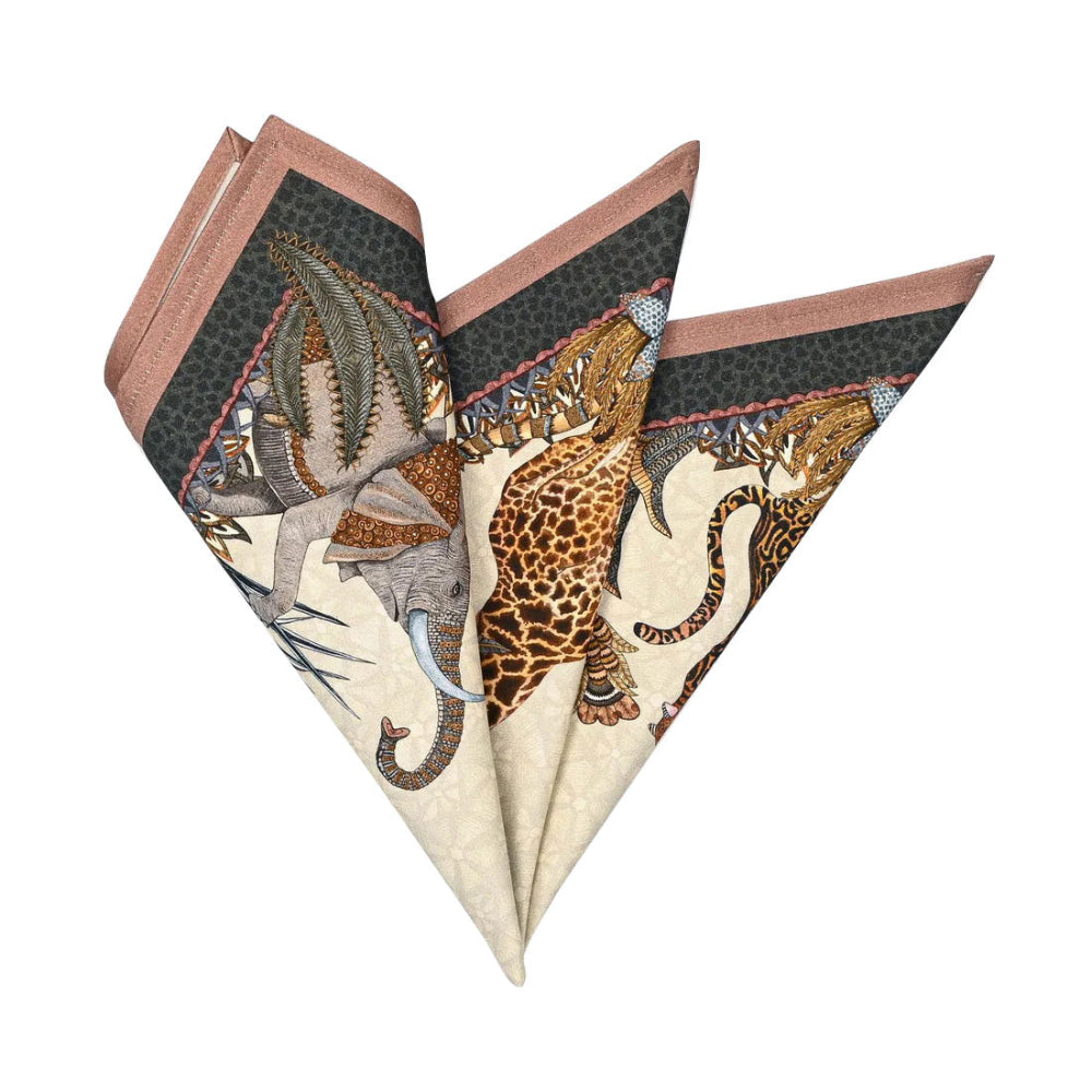 Sabie Forest Napkin folded into a decorative fan shape, showing giraffe, elephant, tiger, and botanical artwork in cream, dark green, brown, and dusty rose tones.