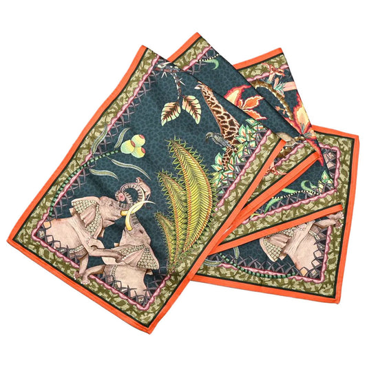 The Sabie Forest Table Runner Large neatly folded in overlapping layers, featuring a dark teal textured background adorned with safari illustrations of elephants and giraffes, framed by an orange outer trim.