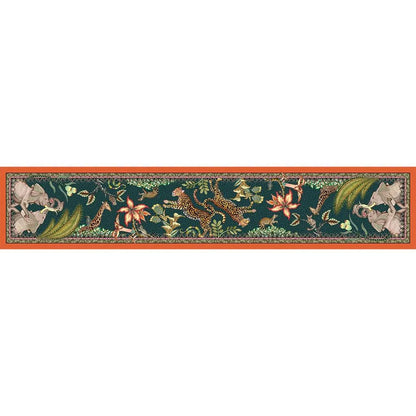 Full horizontal view of the Sabie Forest Table Runner Large laid flat, showing a dark teal base with intricate illustrations of elephants, leopards, a giraffe, and tropical flora bordered by an orange hem.