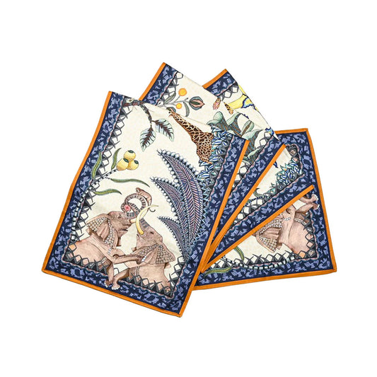 The Sabie Forest Table Runner Small neatly folded into layered sections, highlighting its cream background, detailed safari illustrations of elephants and giraffes, a navy blue ornate border, and an orange outer edge.