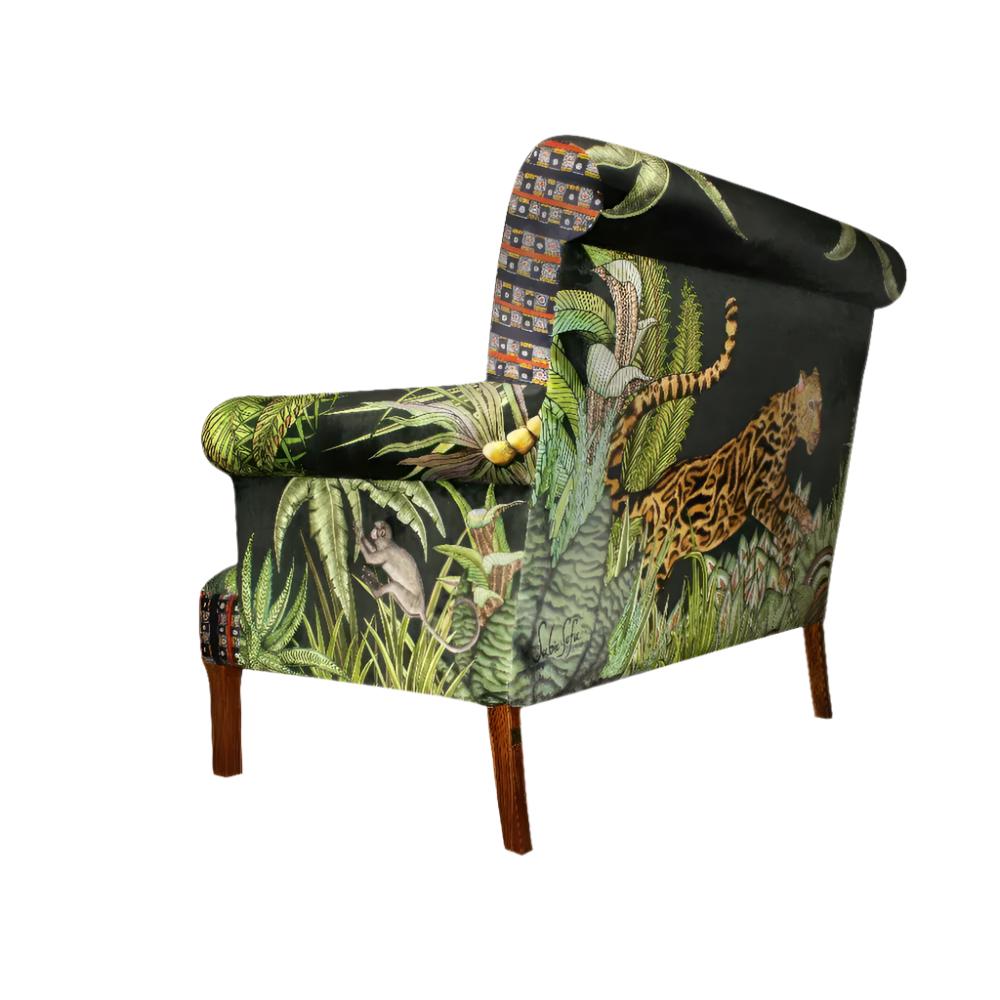 Rear three-quarter view of the Sabie Sofa highlighting the back upholstery featuring a leaping leopard amidst lush green jungle foliage.