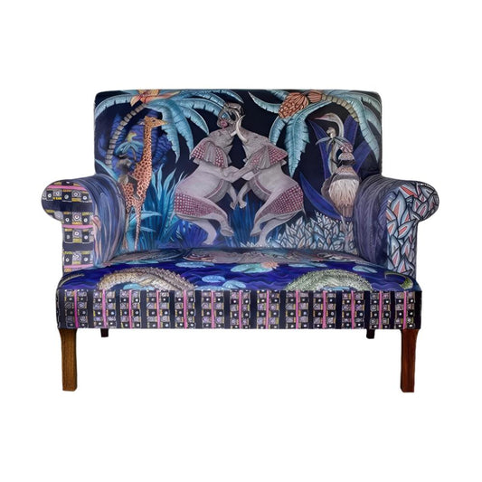 Front view of the Sabie Sofa featuring blue-toned upholstery illustrated with safari animals, including two interactive elephants on the backrest, crocodiles on the seat cushion, and a geometric border.