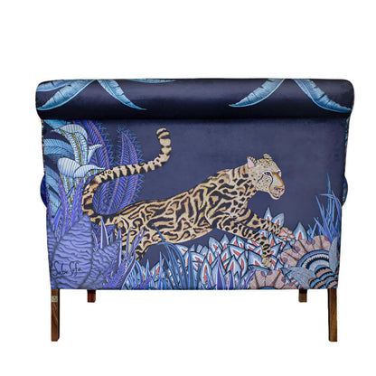 Back view of the Sabie Sofa upholstered in dark blue fabric featuring a large, detailed illustration of a leaping leopard amidst tropical flora.