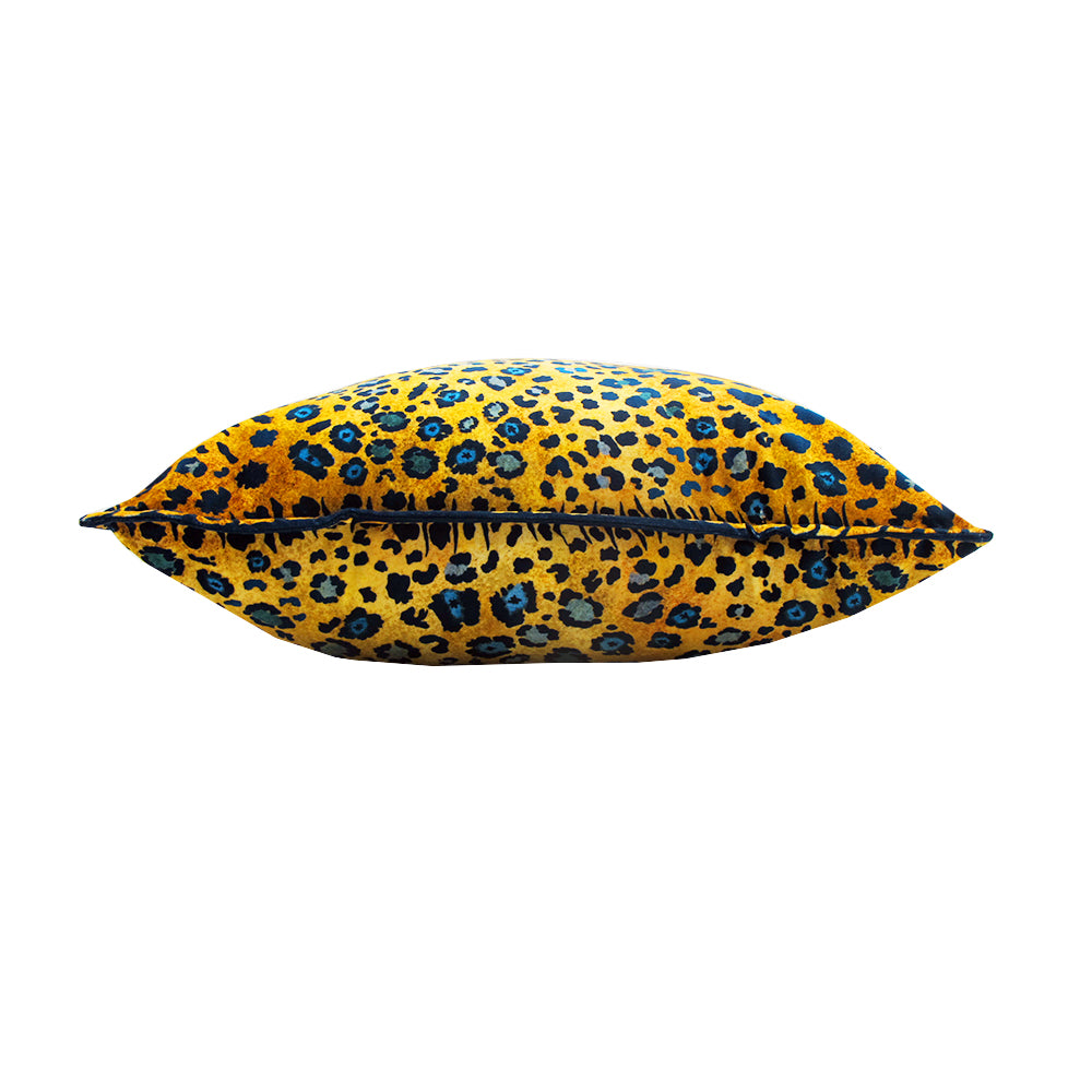 Side view of the Safari Spot Pillow showing the plush square shape, leopard print fabric, and dark piping along the edge.
